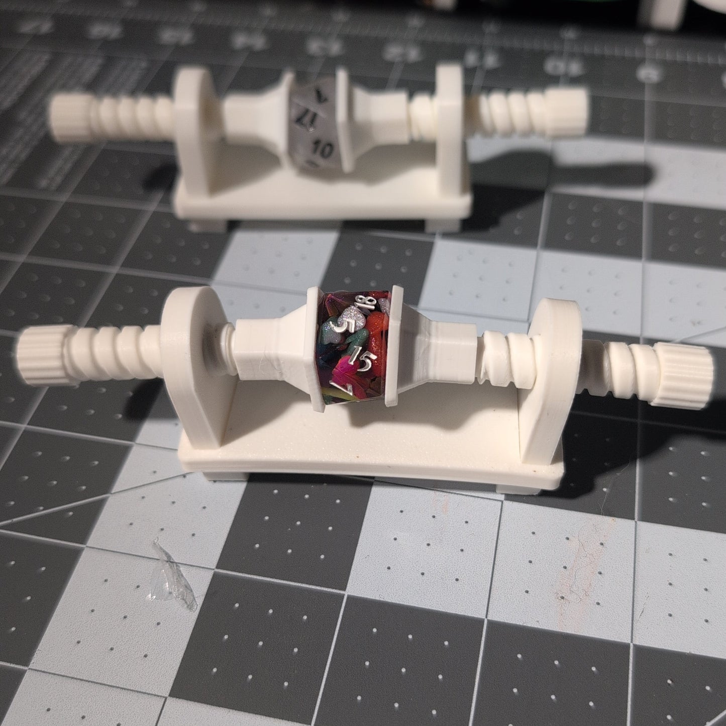 a plastic vice that clamps dice into place.